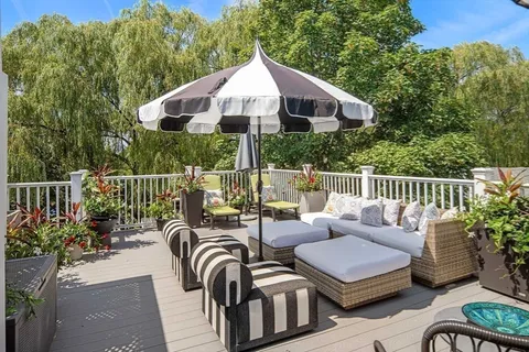 a view of a chair and tables back yard of the house