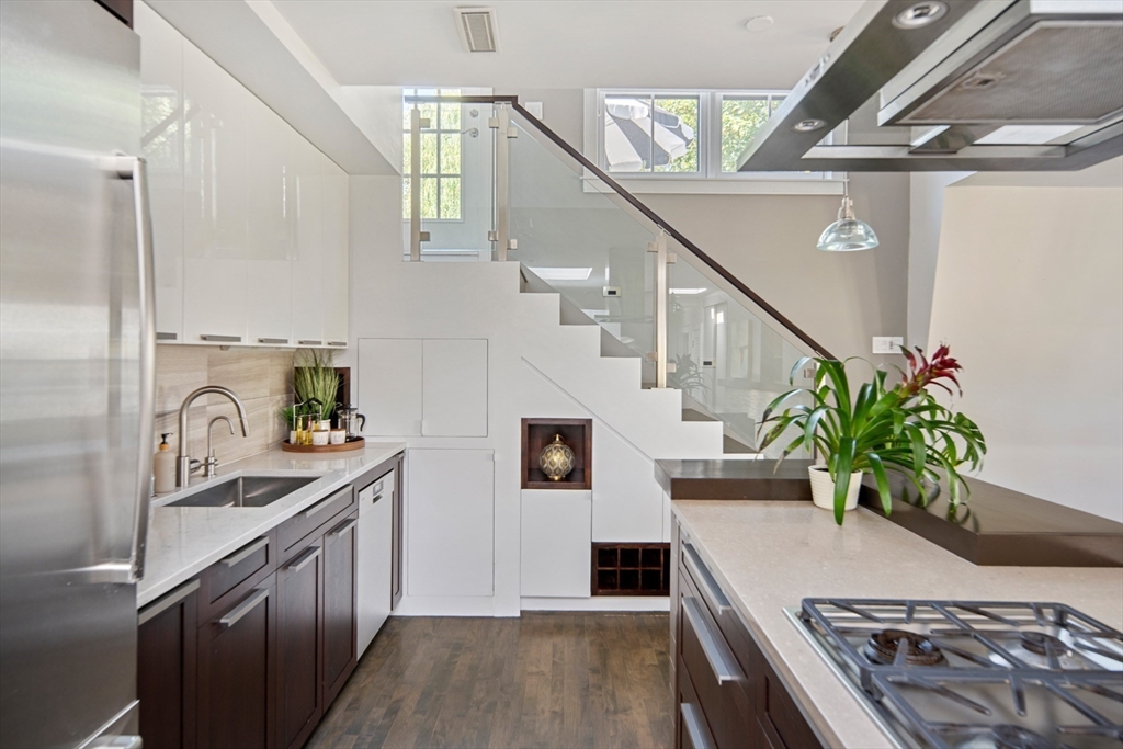 85 Sherman Street, Unit 10 Cambridge, MA 02140 - Photo 2 of 21 a kitchen with sink stove and cabinets