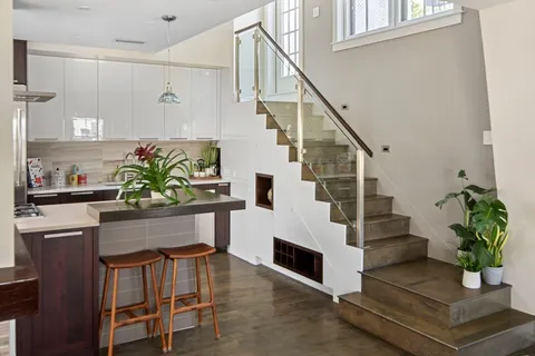 a living room with furniture potted plant and a fireplace