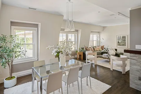 a view of a dining room with furniture window and wooden floor
