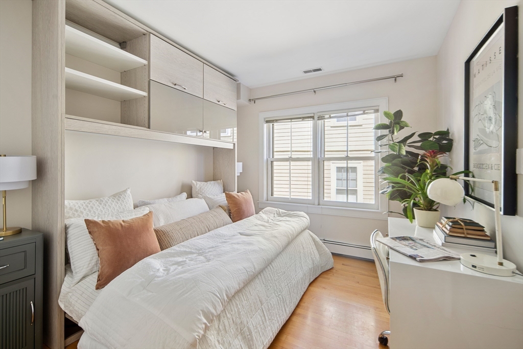 85 Sherman Street, Unit 10 Cambridge, MA 02140 - Photo 9 of 21 a living room with furniture and a large window