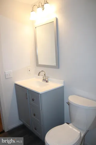 a bathroom with a toilet a sink and mirror