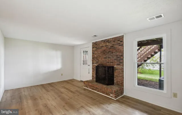 a view of empty room with window and fireplace