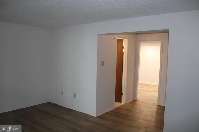an empty room with wooden floor and closet