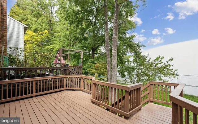 a view of balcony with wooden floor and fence