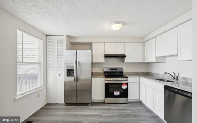 a kitchen with a refrigerator and a sink