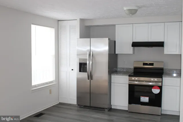 a kitchen with stainless steel appliances a refrigerator microwave and stove