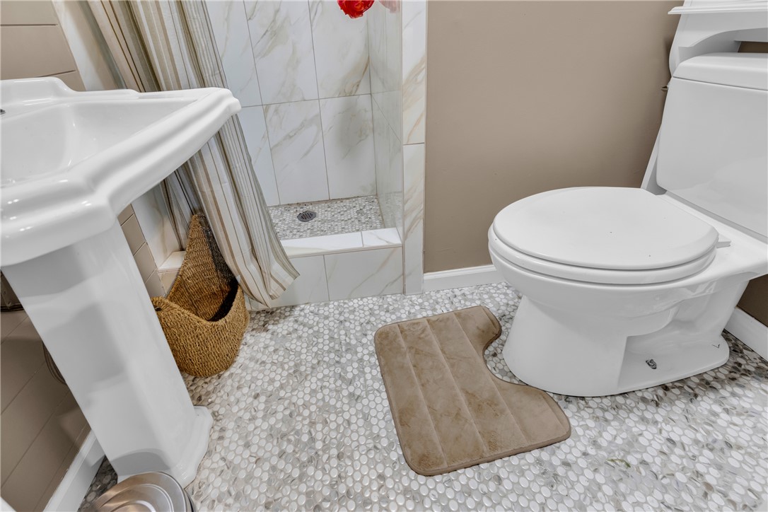 3030 Smith McGee Road Iva, SC 29655 - Photo 37 of 46 Tiled flooring and a modern shower with stone accents define this fresh bathroom space.
