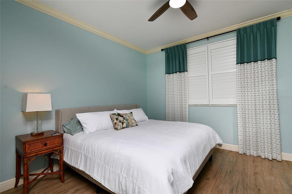 3321 Sunset Key Circle, Unit 408 Punta Gorda, FL 33955 - Photo 11 of 42 a bedroom with a bed and a lamp on the dresser