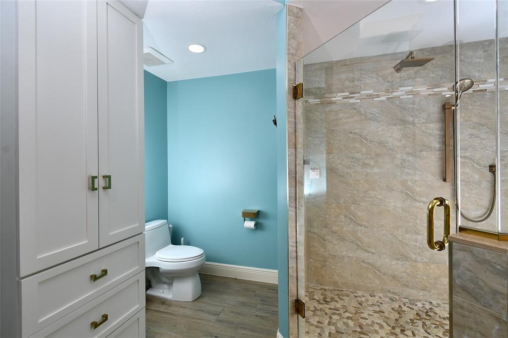 3321 Sunset Key Circle, Unit 408 Punta Gorda, FL 33955 - Photo 27 of 42 a bathroom with a granite countertop toilet a sink and shower