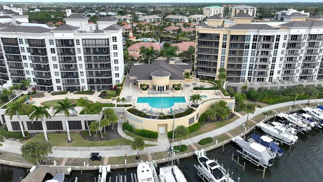 an aerial view of residential houses with outdoor space and parking