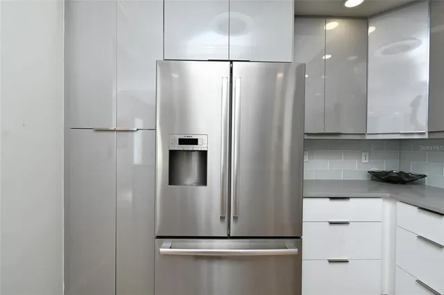 a view of cabinets and refrigerator