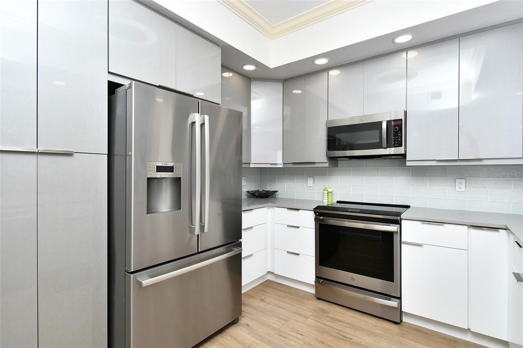 3321 Sunset Key Circle, Unit 408 Punta Gorda, FL 33955 - Photo 8 of 42 a kitchen with stainless steel appliances a refrigerator stove and microwave