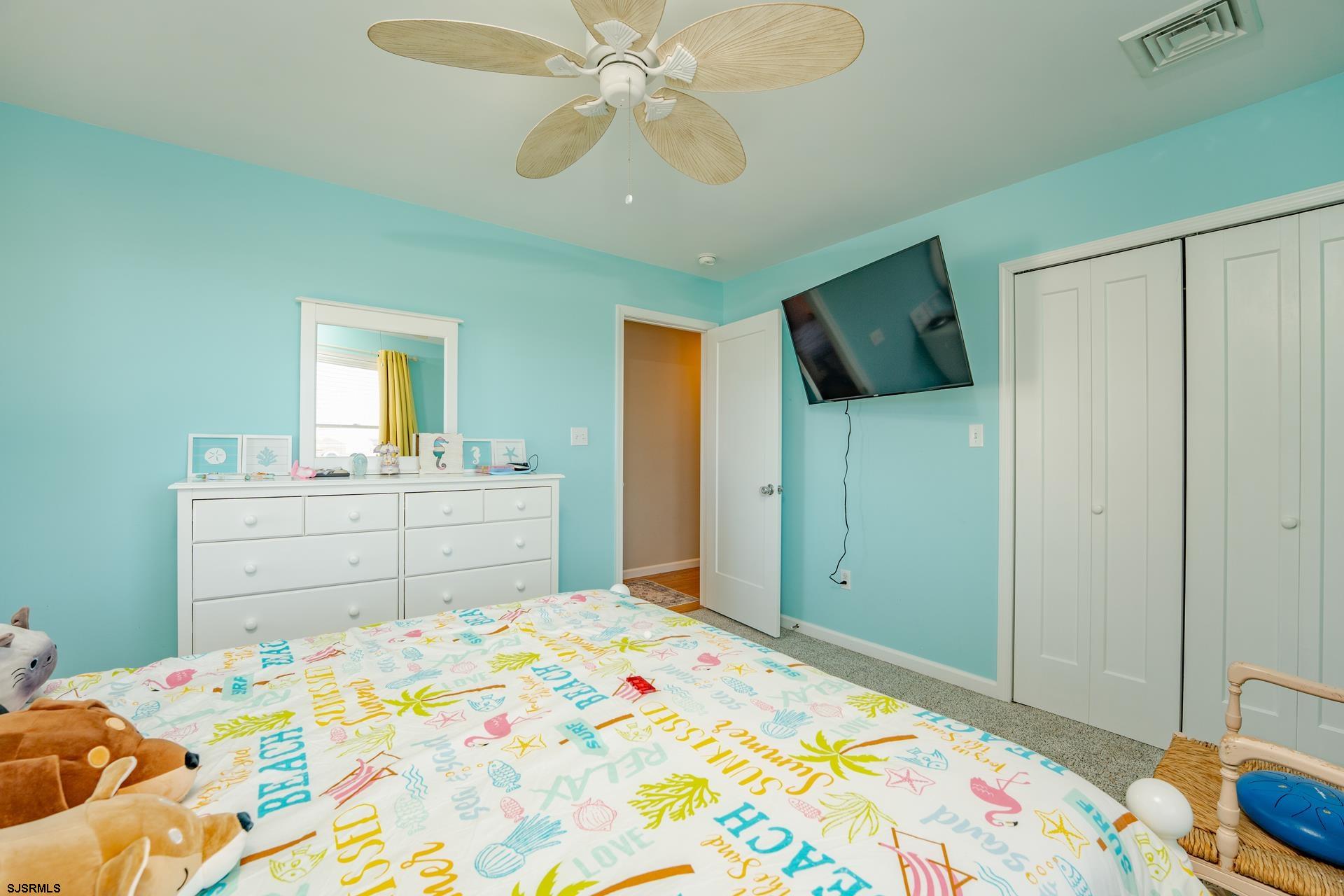 703 Bobby Jones Road Brigantine, NJ 08203 - Photo 16 of 34 a bedroom with a bed and a chandelier