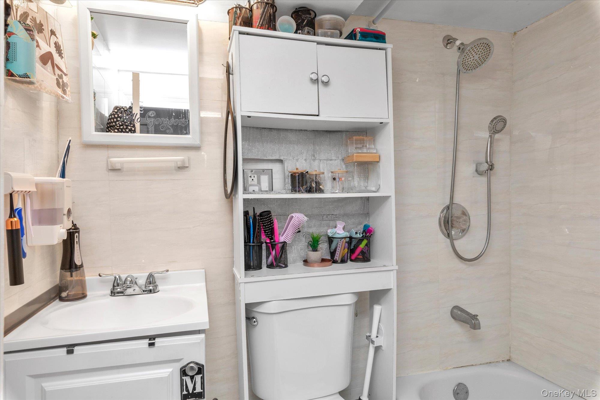 218-12 141st Road Queens, NY 11413 - Photo 11 of 21 a bathroom with a sink vanity mirror and toilet