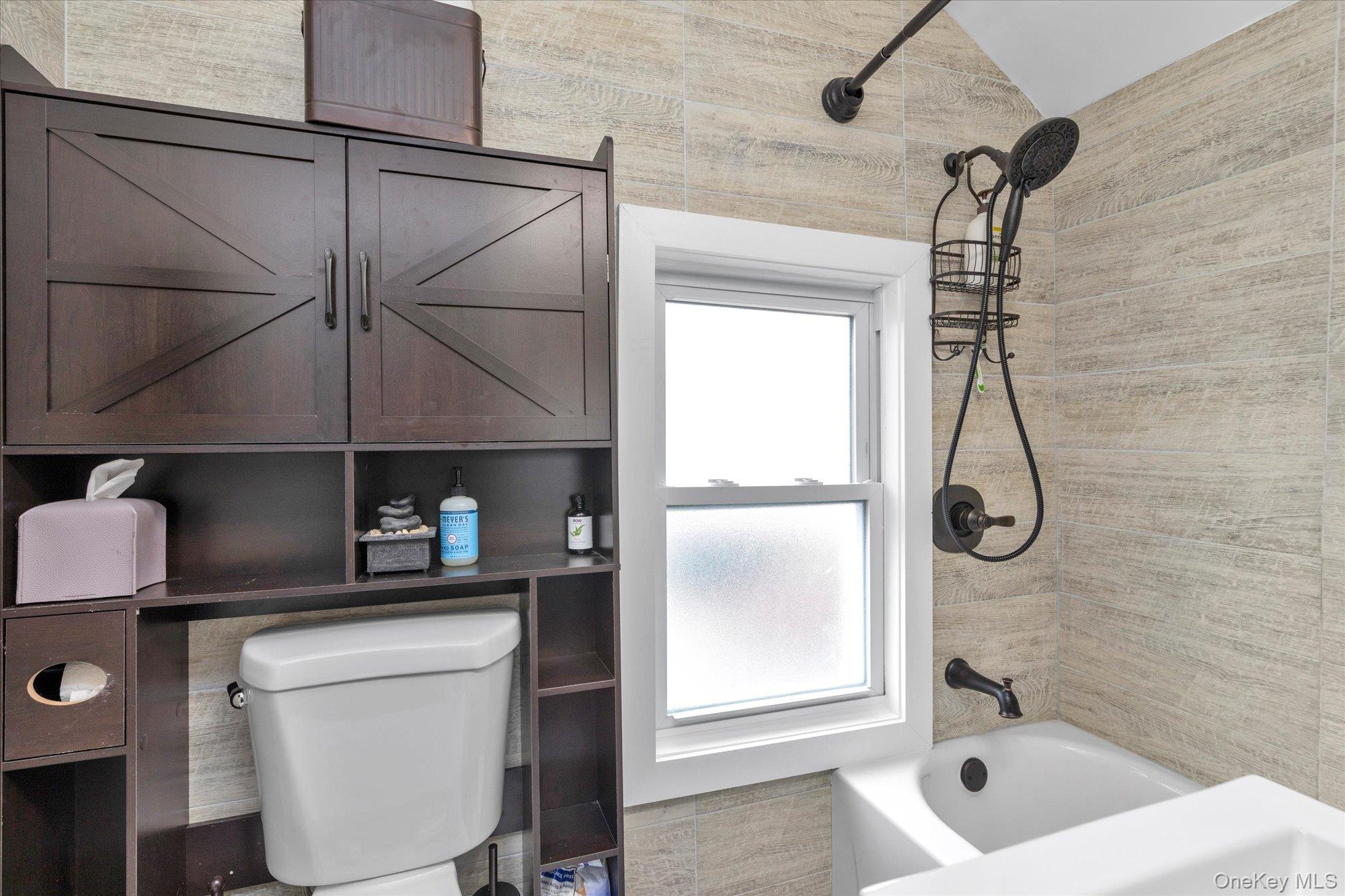 218-12 141st Road Queens, NY 11413 - Photo 20 of 21 a bathroom with a granite countertop sink a toilet and shower