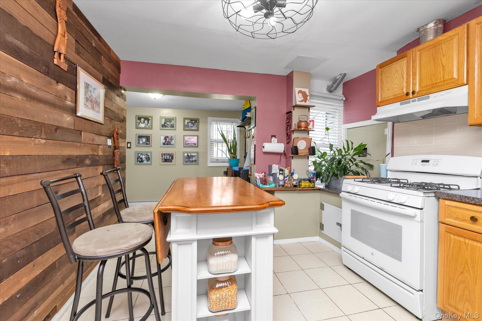 218-12 141st Road Queens, NY 11413 - Photo 6 of 21 a kitchen with a stove a table and chairs