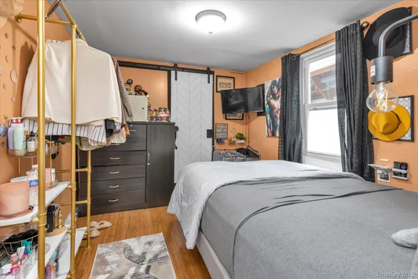 a bedroom with a bed and large windows