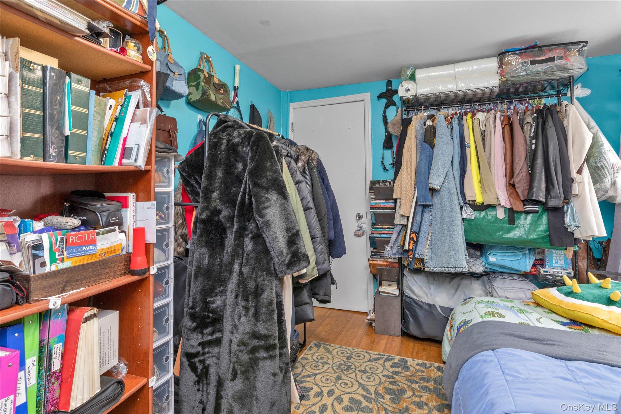 218-12 141st Road Queens, NY 11413 - Photo 9 of 21 a view of walk in closet with clothes and shoes