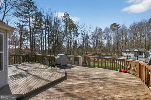 a view of balcony with wooden floor and outdoor seating