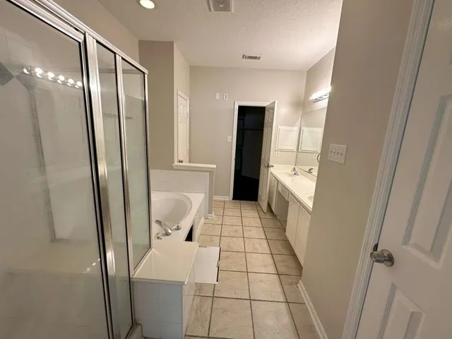 a bathroom with a sink a toilet and a shower