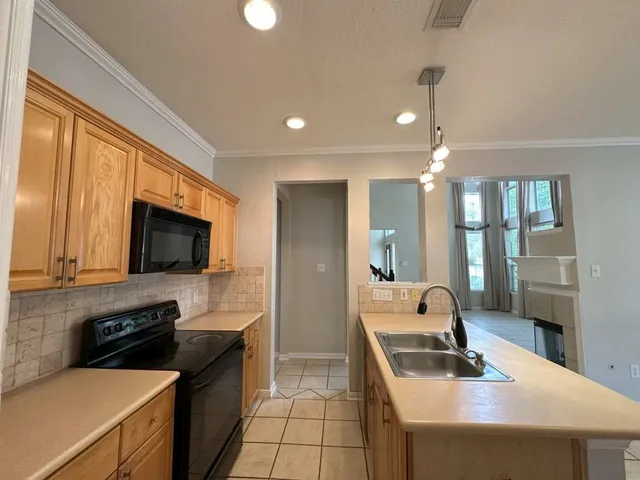 a kitchen with a stove a sink and a refrigerator