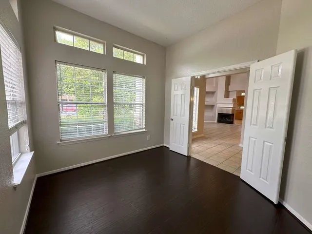 a view of a livingroom with wooden floor and a window