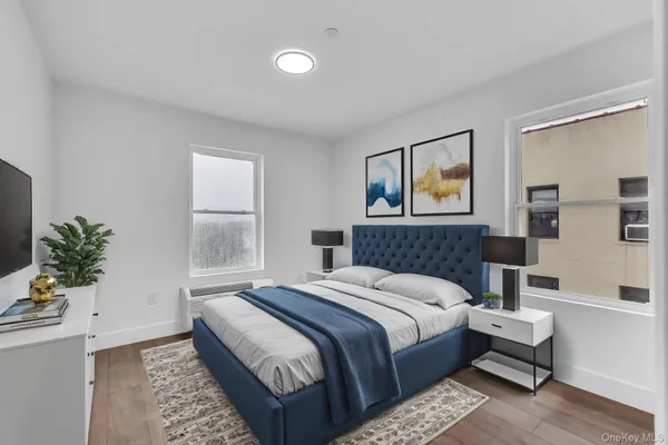 a bedroom with a large bed and a potted plant