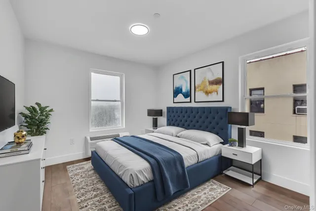 a bedroom with a large bed and a potted plant