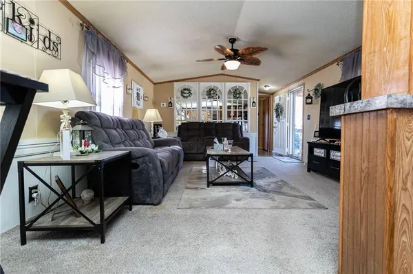 a view of a livingroom with furniture and a ceiling fan