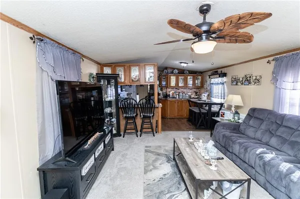 a kitchen with stainless steel appliances granite countertop a stove top oven a sink dishwasher and cabinets with wooden floor