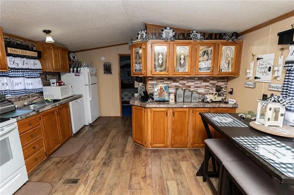 a kitchen with stainless steel appliances granite countertop a stove sink and cabinets
