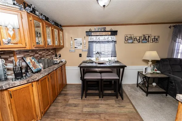 a kitchen with granite countertop a sink stove and cabinets