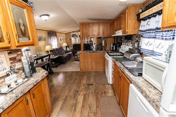 a bedroom with a large bed and wooden floor