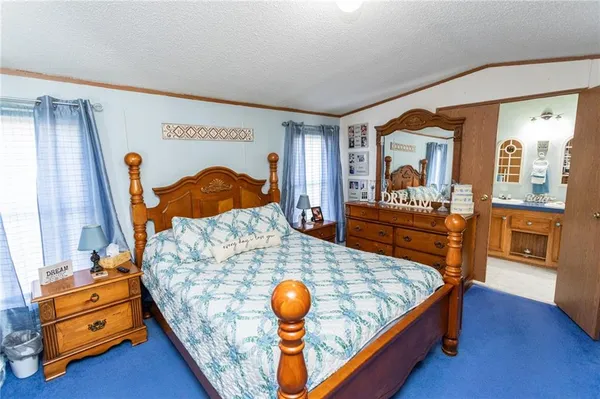 a bedroom with a bed and a view of bedroom