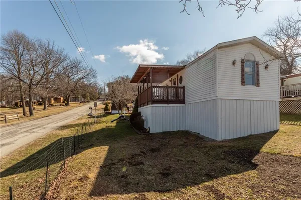 a view of a house with backyard and trees