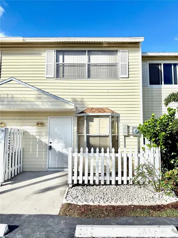 a front view of a house with lots of yellow lighting