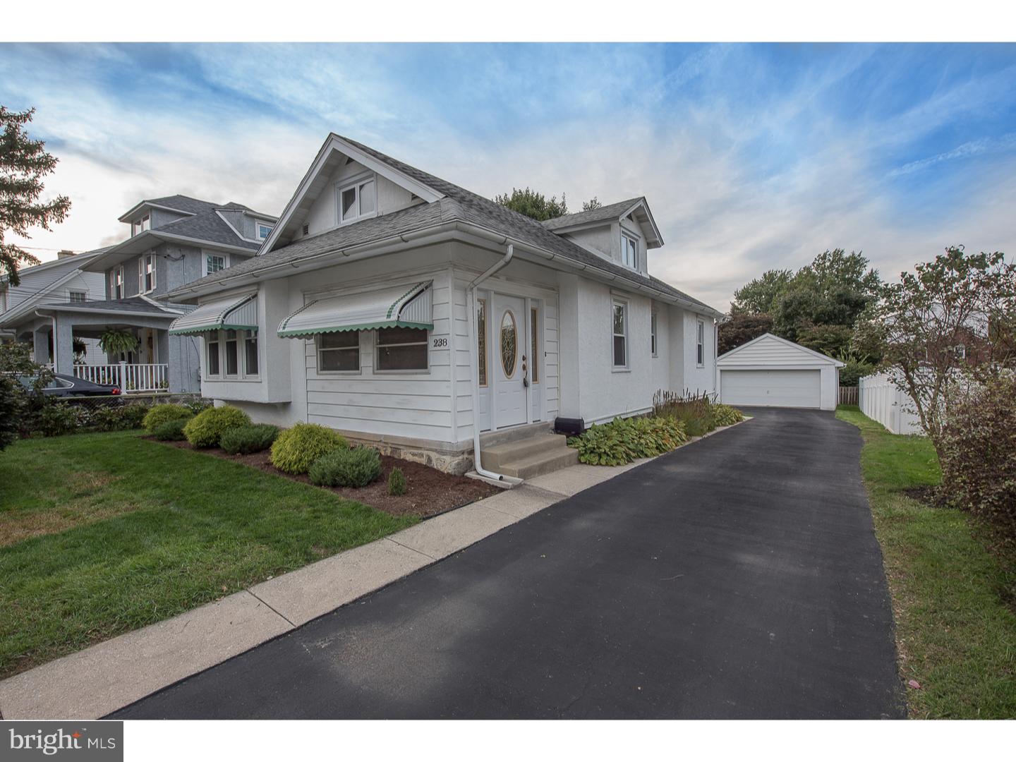 238 Strathmore Road Havertown, PA 19083 - Photo 1 of 25 a front view of a house with a yard and garage