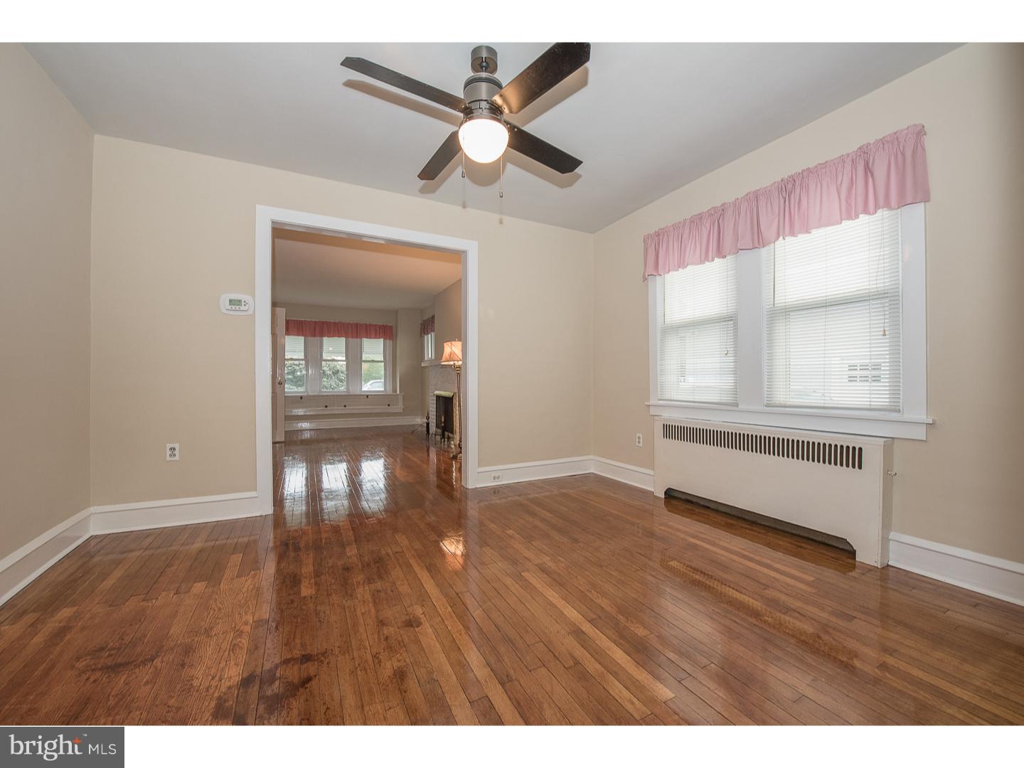 238 Strathmore Road Havertown, PA 19083 - Photo 8 of 25 a view of an empty room with wooden floor and a window