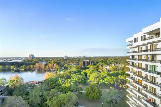 an aerial view of a house with a yard and lake view