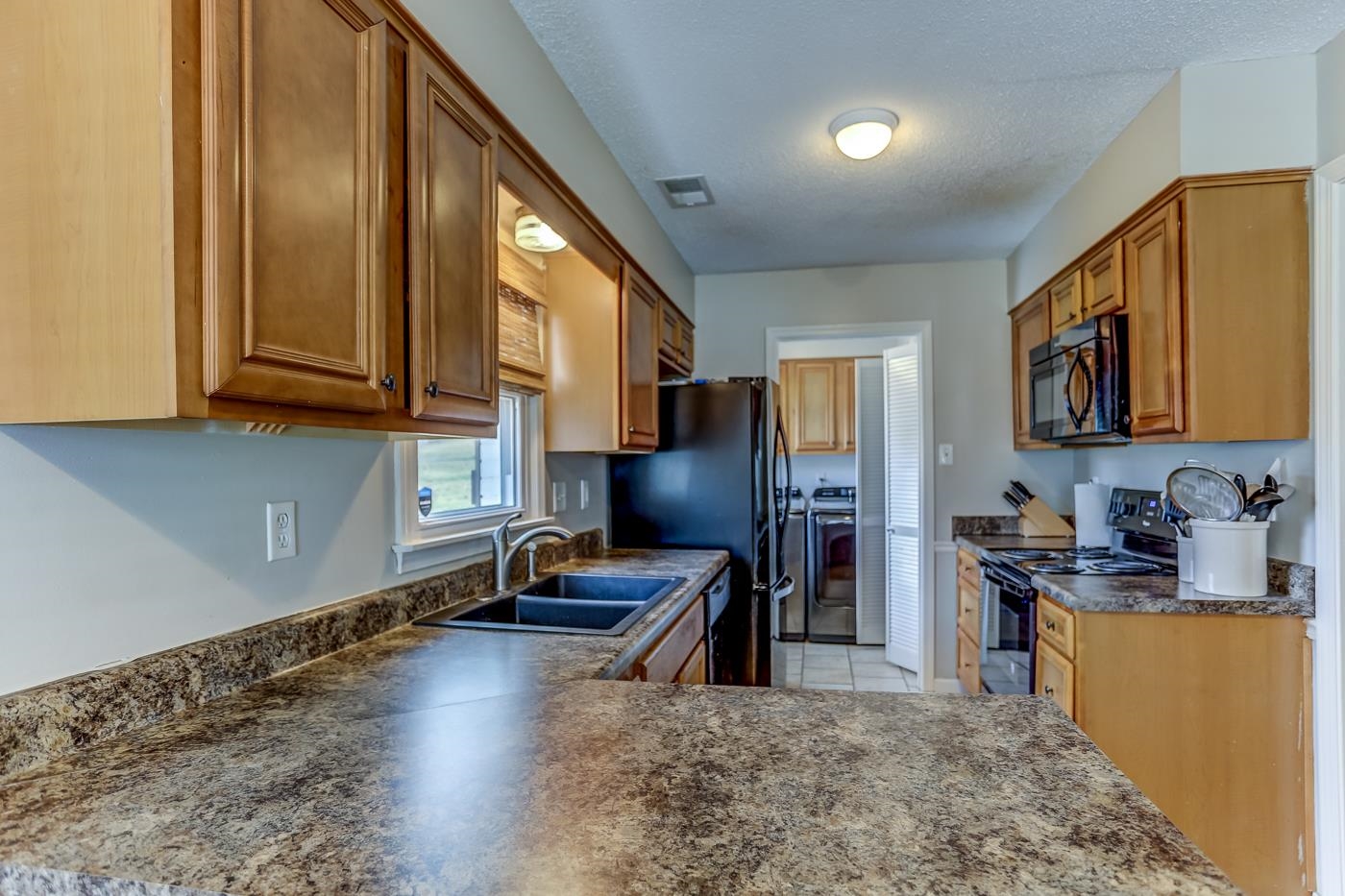 293 Glen Echo Road Collierville, TN 38017 - Photo 12 of 33 a kitchen with stainless steel appliances granite countertop a refrigerator stove top oven a sink and dishwasher