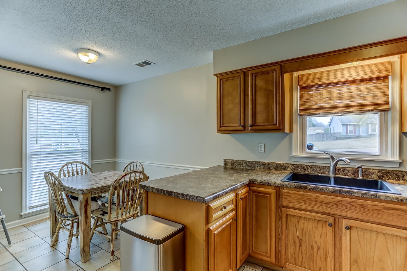 293 Glen Echo Road Collierville, TN 38017 - Photo 13 of 33 a kitchen with a stove a sink and a refrigerator