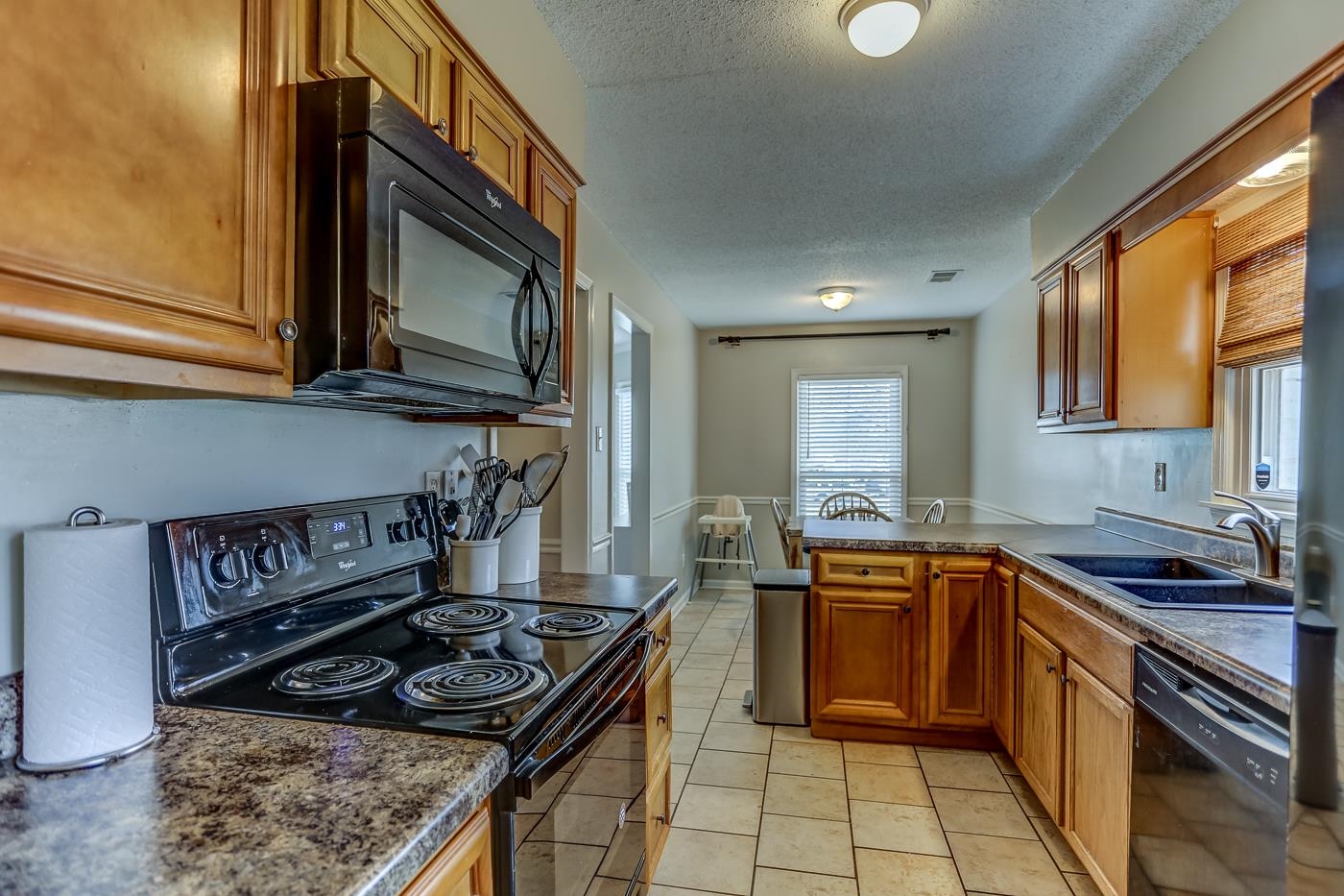 293 Glen Echo Road Collierville, TN 38017 - Photo 14 of 33 a kitchen with a stove a sink and a microwave