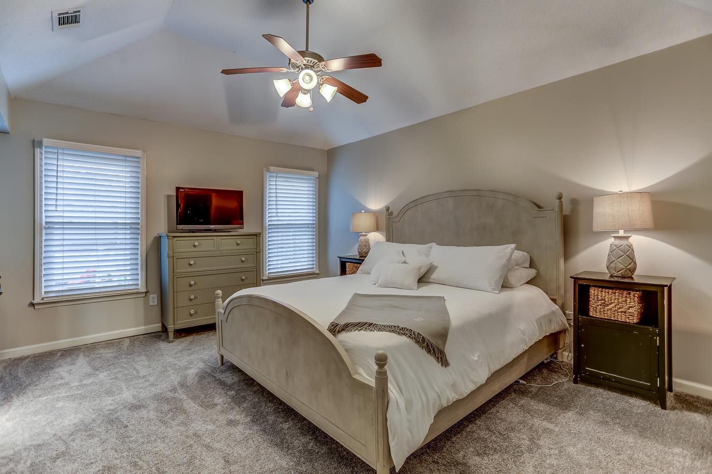 293 Glen Echo Road Collierville, TN 38017 - Photo 15 of 33 a spacious bedroom with a bed and a chandelier