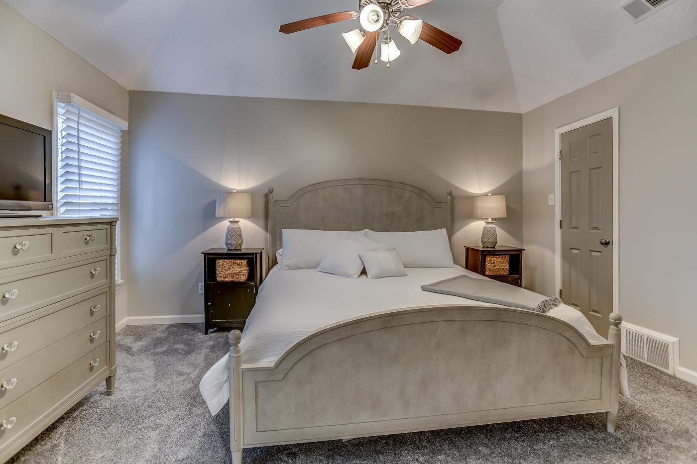 293 Glen Echo Road Collierville, TN 38017 - Photo 16 of 33 a bedroom with a bed and a chandelier