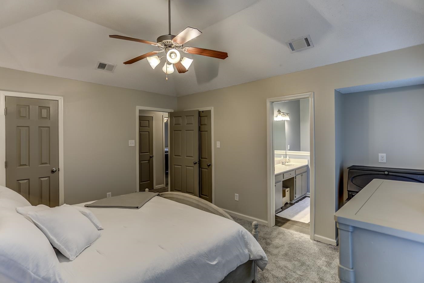 293 Glen Echo Road Collierville, TN 38017 - Photo 17 of 33 a bedroom with a bed and a chandelier