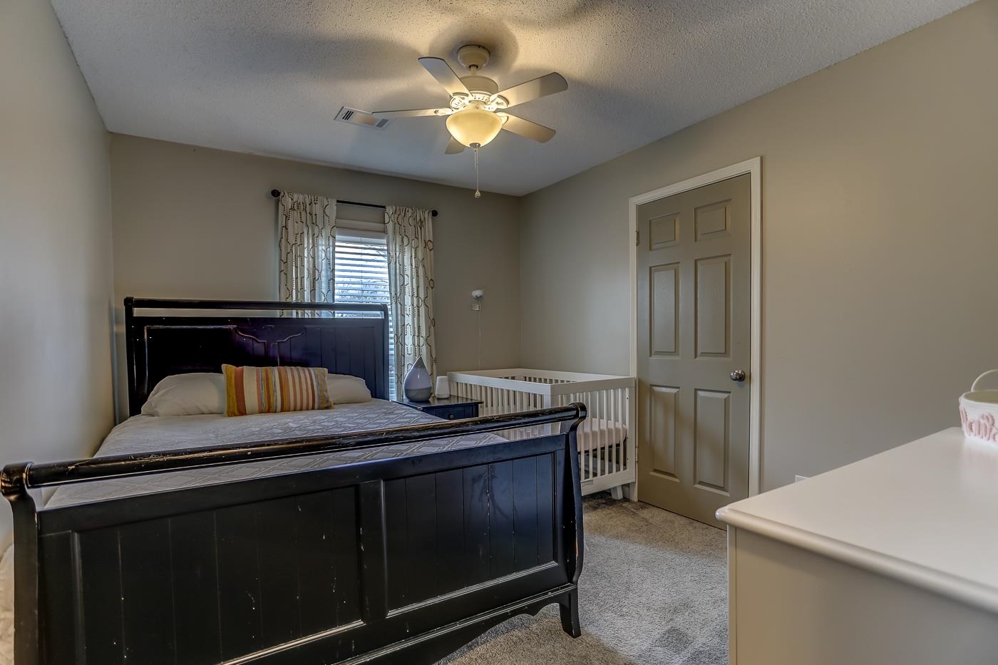 293 Glen Echo Road Collierville, TN 38017 - Photo 22 of 33 a bedroom with a bed and a table