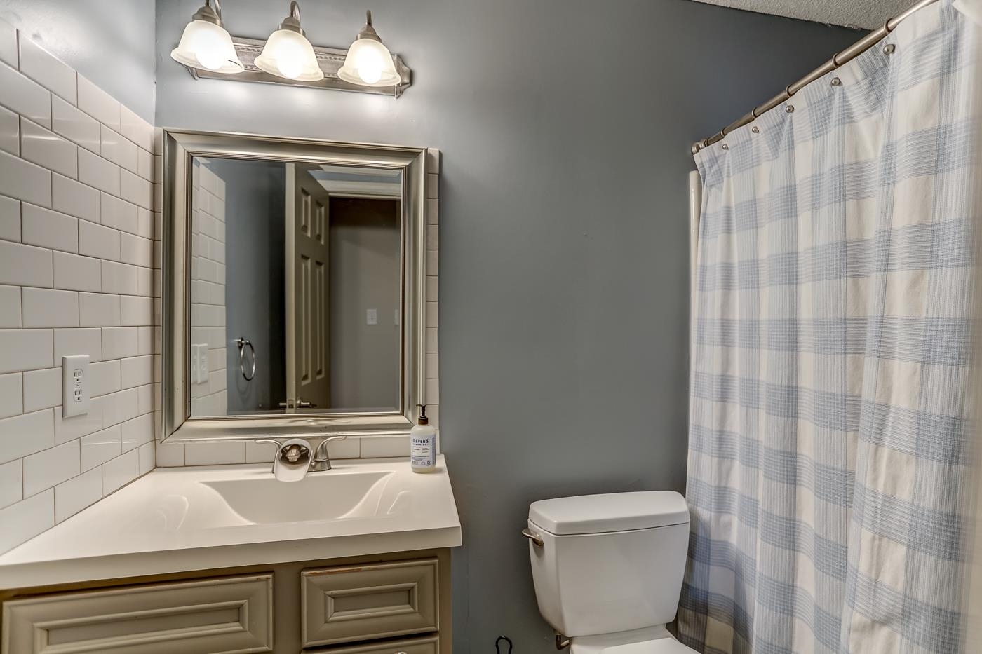 293 Glen Echo Road Collierville, TN 38017 - Photo 23 of 33 a bathroom with a sink and a mirror