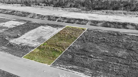 a view of a yard with wooden fence