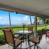 a view of a porch with furniture and a yard